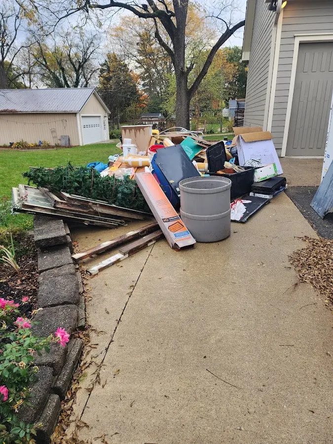 Dumpster being loaded with debris for Estate Cleanout Dumpster Rental in Collegeville